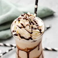 Frozen mudslide in a glass with a black straw.