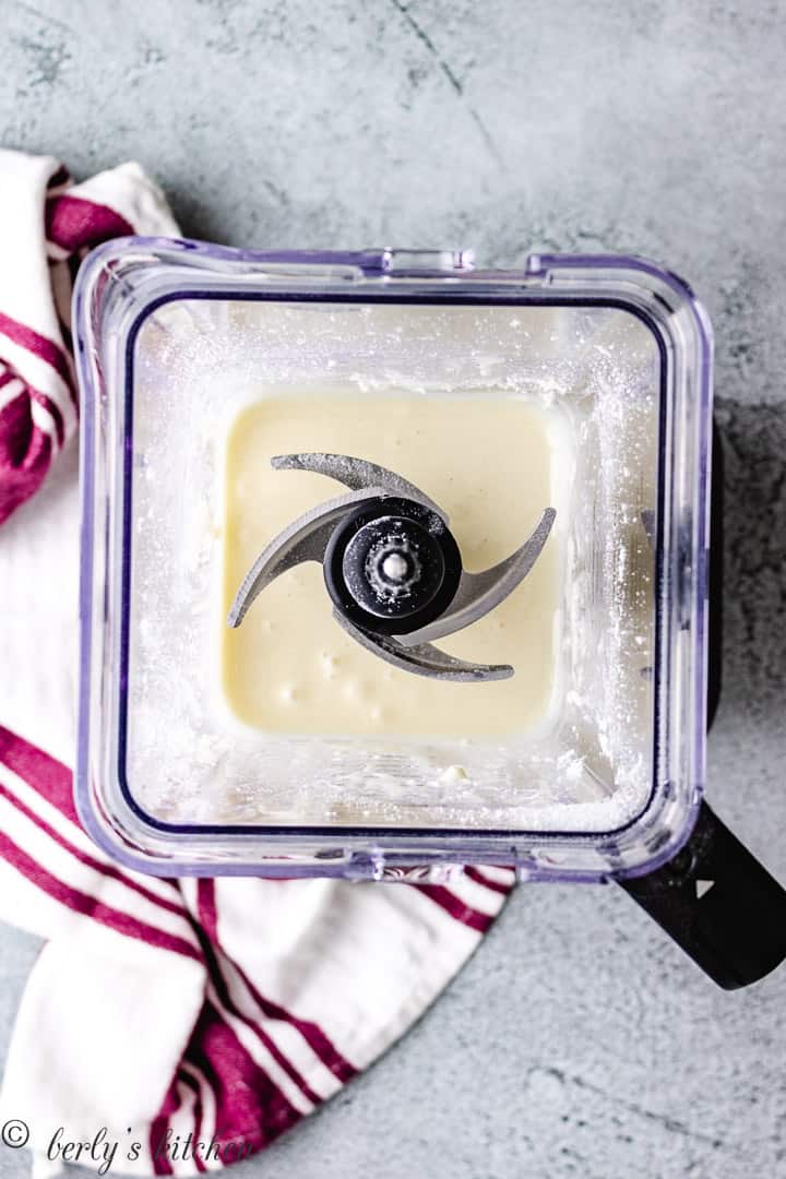 Top down view of sweetened condensed milk in a blender.