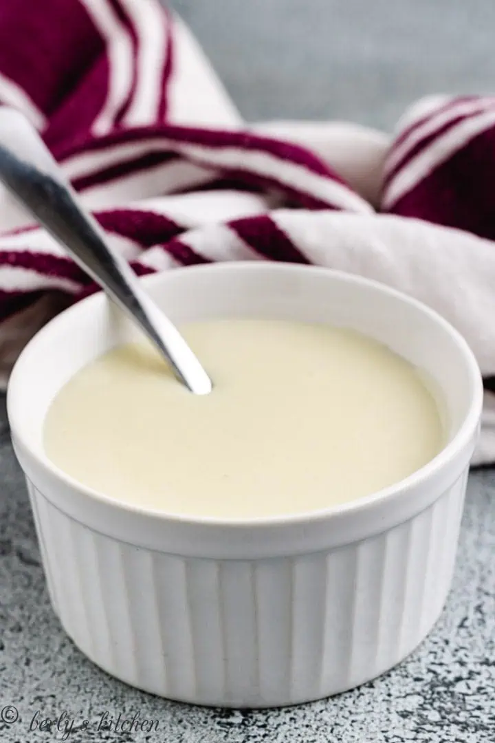 Close up of a ramekin of sweetened condensed milk.