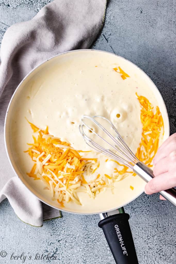 Roux in a pan with shredded cheese.