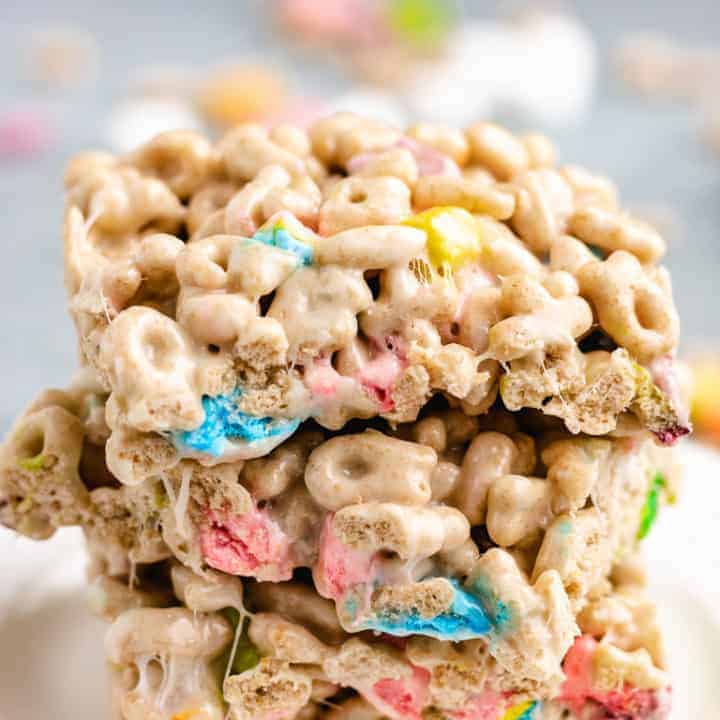 Lucky Charms Treats Marshmallow treats stacked on a white plate.