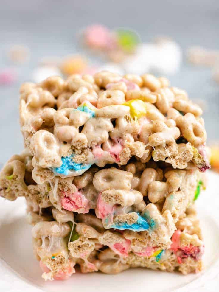 Marshmallow treats stacked on a white plate.