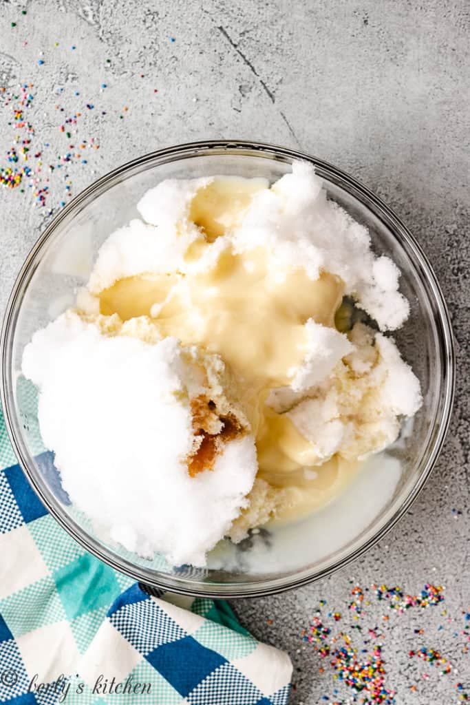Snow, sweetened condensed milk, and vanilla in a bowl.