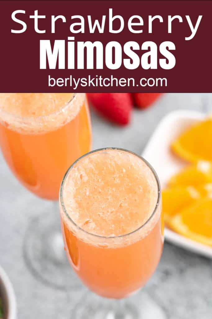 Strawberry Mimosas in champagne glasses.