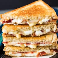 Two bacon grilled cheese sandwiches but in half.