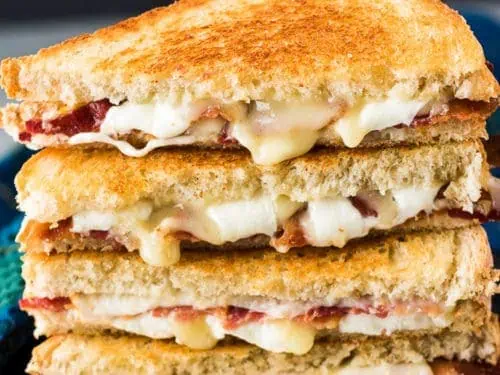 Two bacon grilled cheese sandwiches but in half.