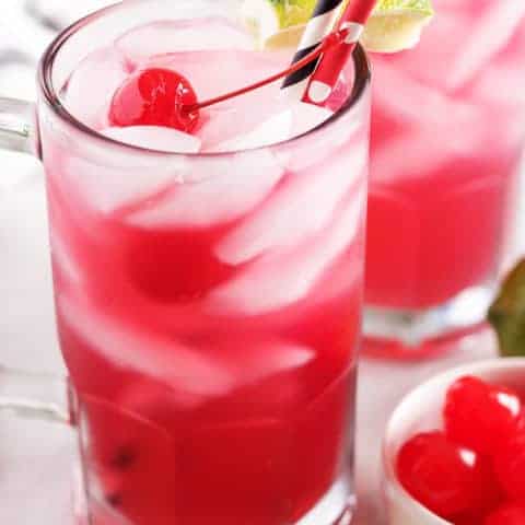 Easy Cherry Limeade Recipe Cherry limeade served in a large mug with a colorful straw.