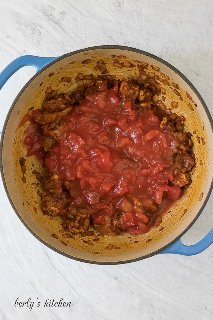 Tomatoes and paprika chicken in a Dutch oven.