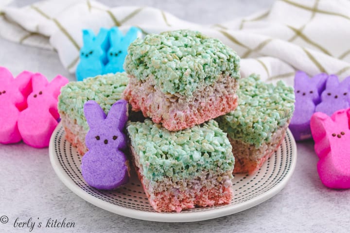 Layered easter rice krispie treats on a white plate.