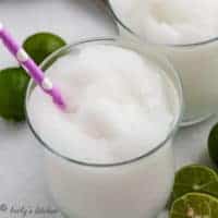 Close up view of a frozen daiquiri with a colorful straw.