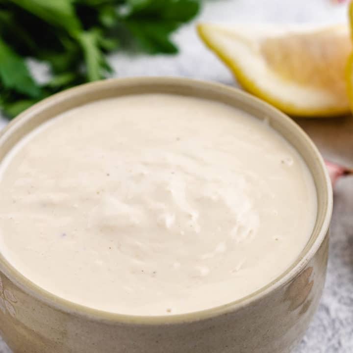 Homemade Caesar Dressing Brown bowl filled with homemade salad dressing.