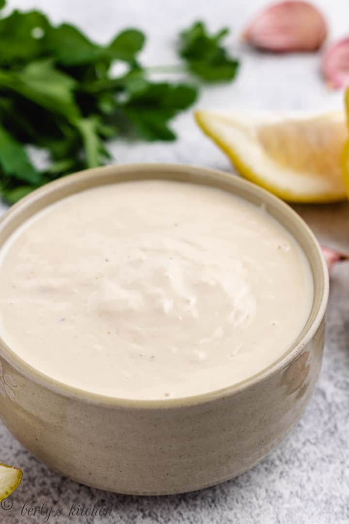 Brown bowl filled with homemade salad dressing.
