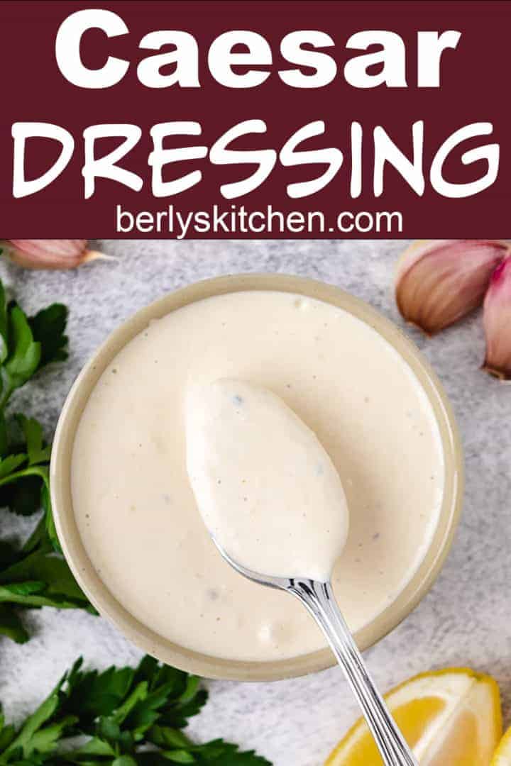 Homemade Caesar dressing on a spoon.