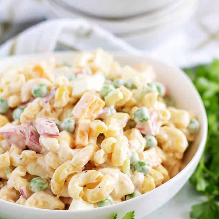 Large white bowl filled with macaroni salad.