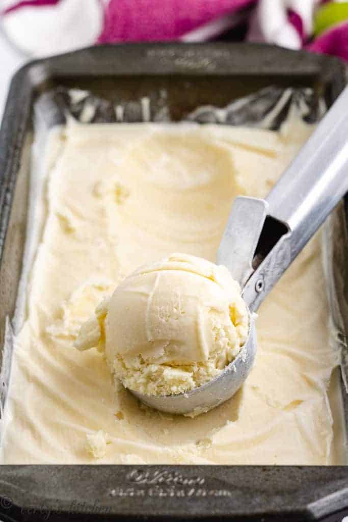 Ice cream being scooped from a loaf pan.