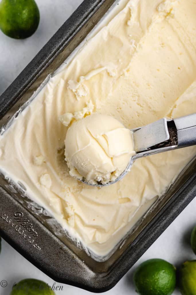Top down view of key lime ice cream being scooped from a pan.