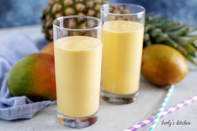 Glasses of mango smoothie with fresh pineapple.