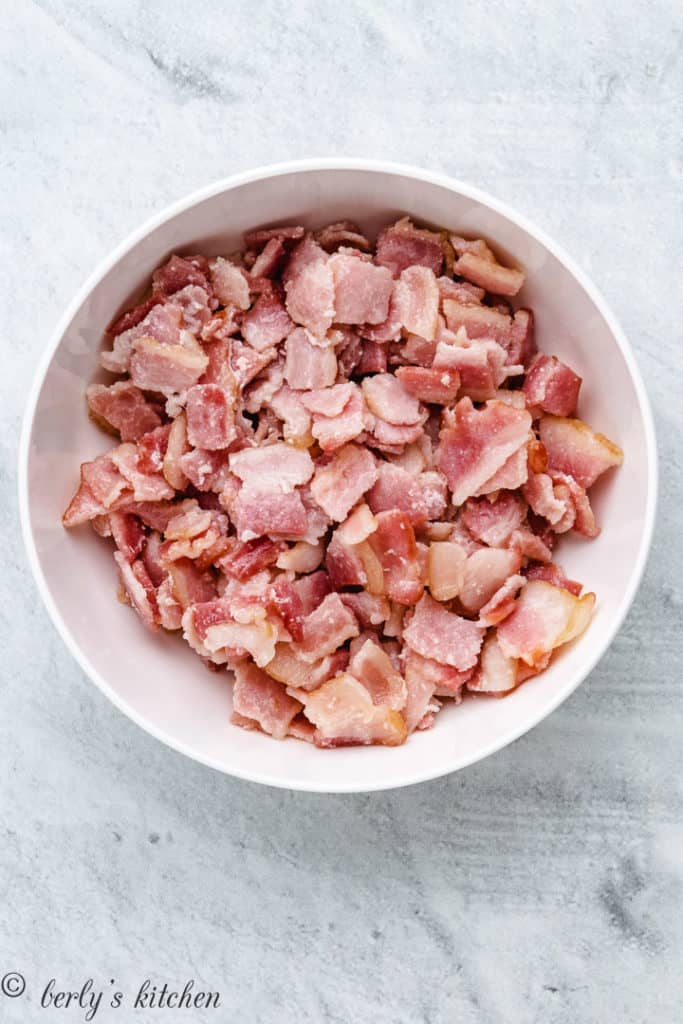 Chopped, partially cooked bacon in a bowl.