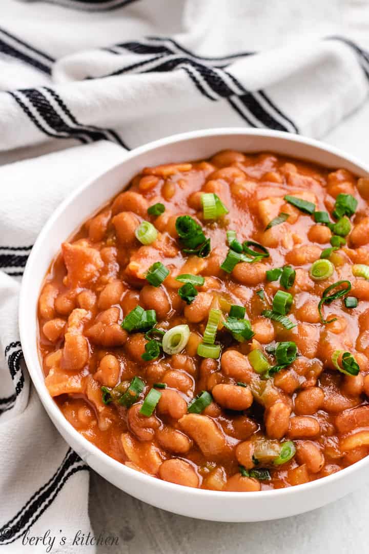 Top down view of baked beans in a dish.