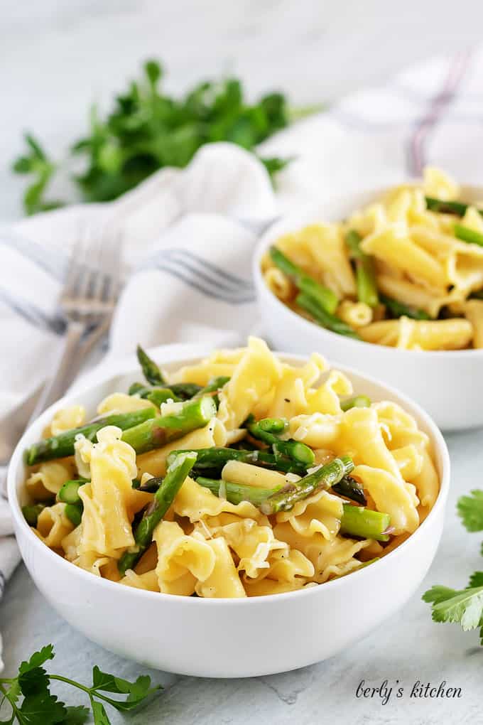 Two bowls of garlic asparagus pasta.