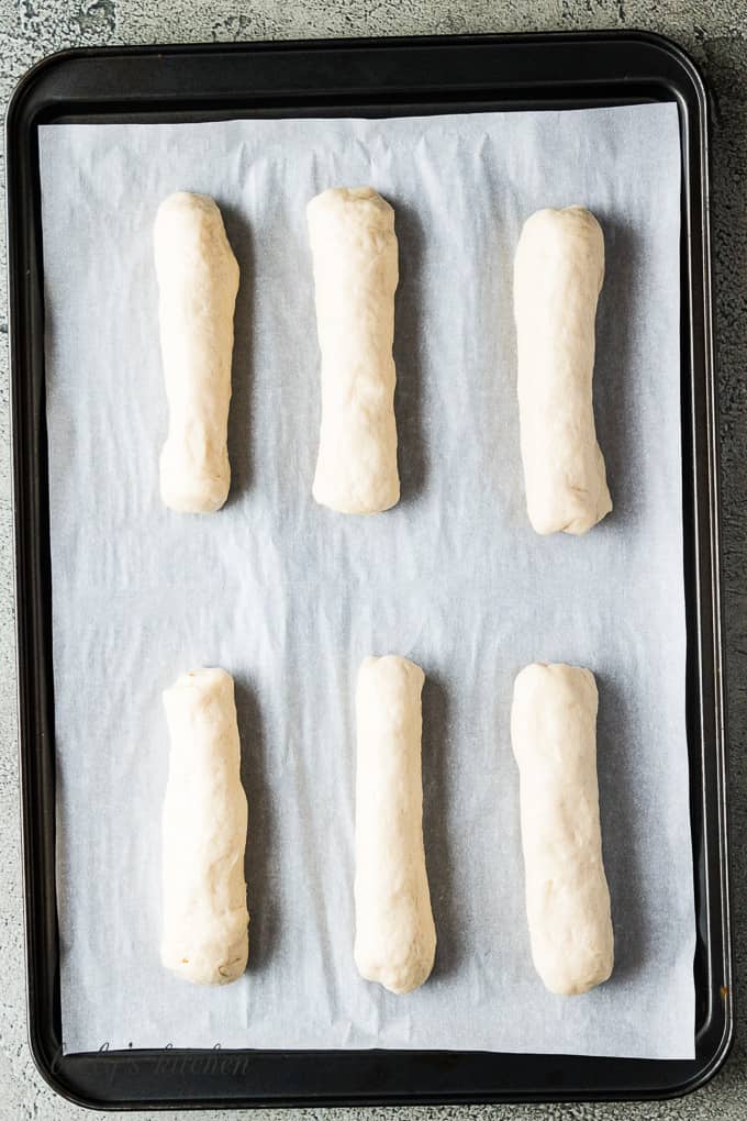 Dough wrapped around each cheese stick with space between each breadstick.