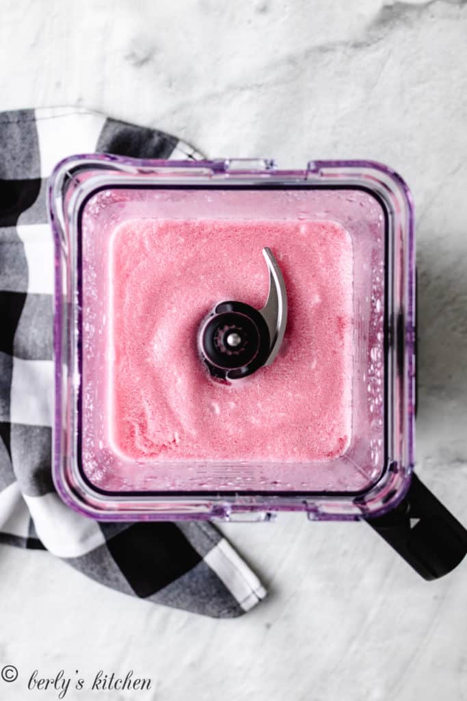 Top down view of a blender filled with frozen cherry limeade.