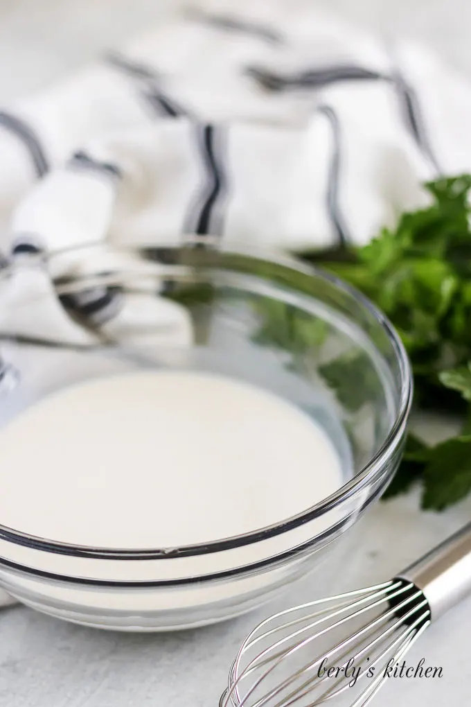 Milk and flour mixed in a glass bowl.