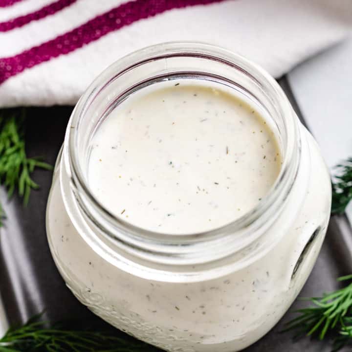 Top down view of dill dressing in a jar.
