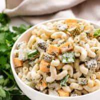 Pasta salad with dill pickles and cheese.