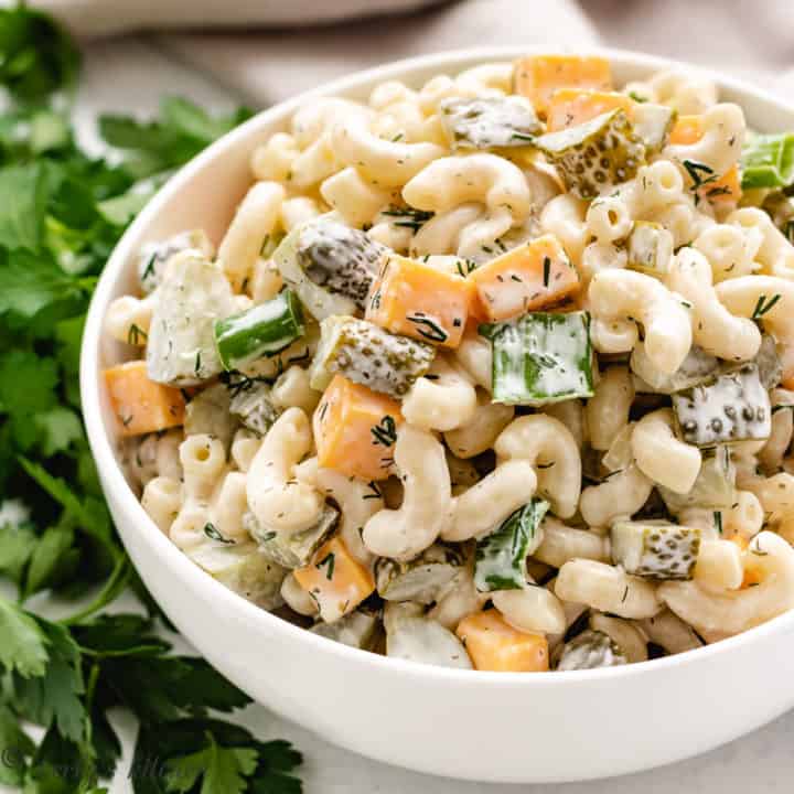 Large white bowl filled dill pickle pasta salad.