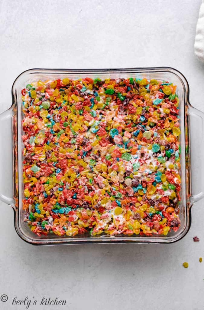 Top down view of fruity pebbles treats in a square pan.