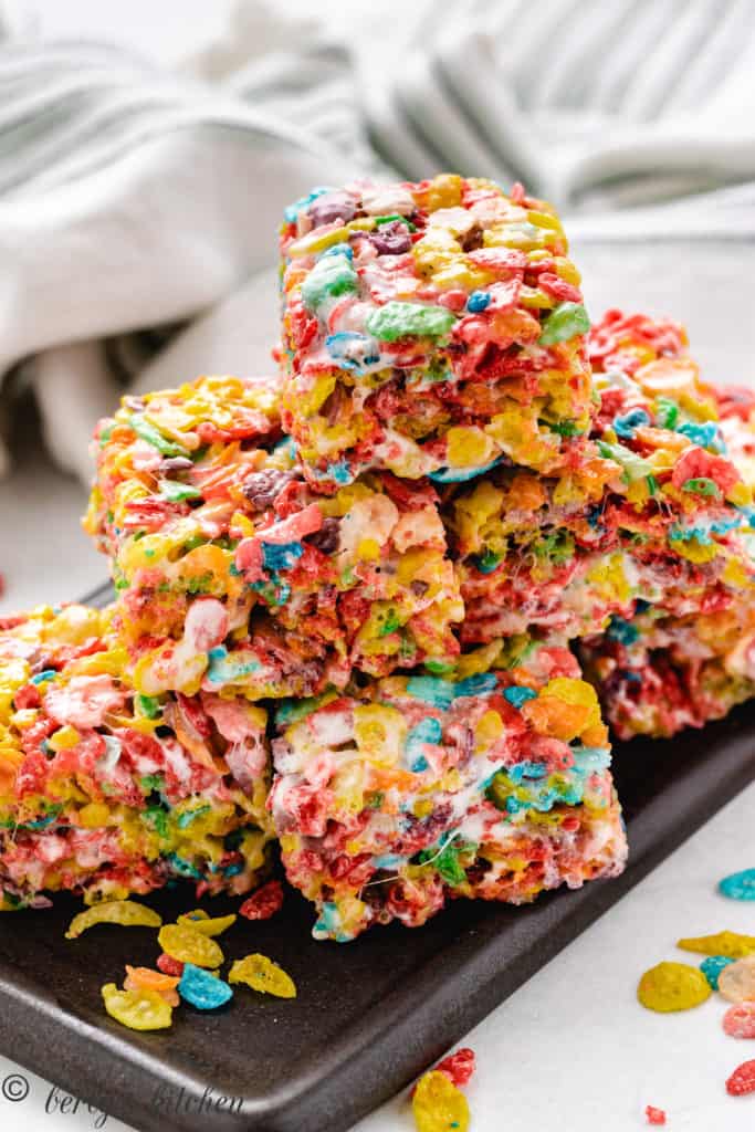 Fruity pebbles treats piled on a plate.