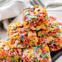 Cereal treats stacked on a black platter.