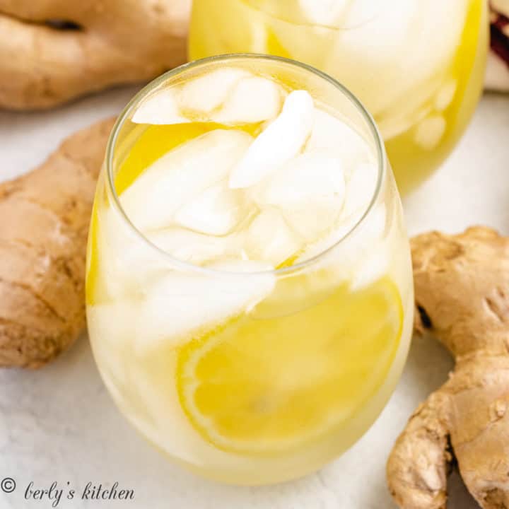 Easy Ginger Lemonade Two glasses of lemonade next to ginger root.