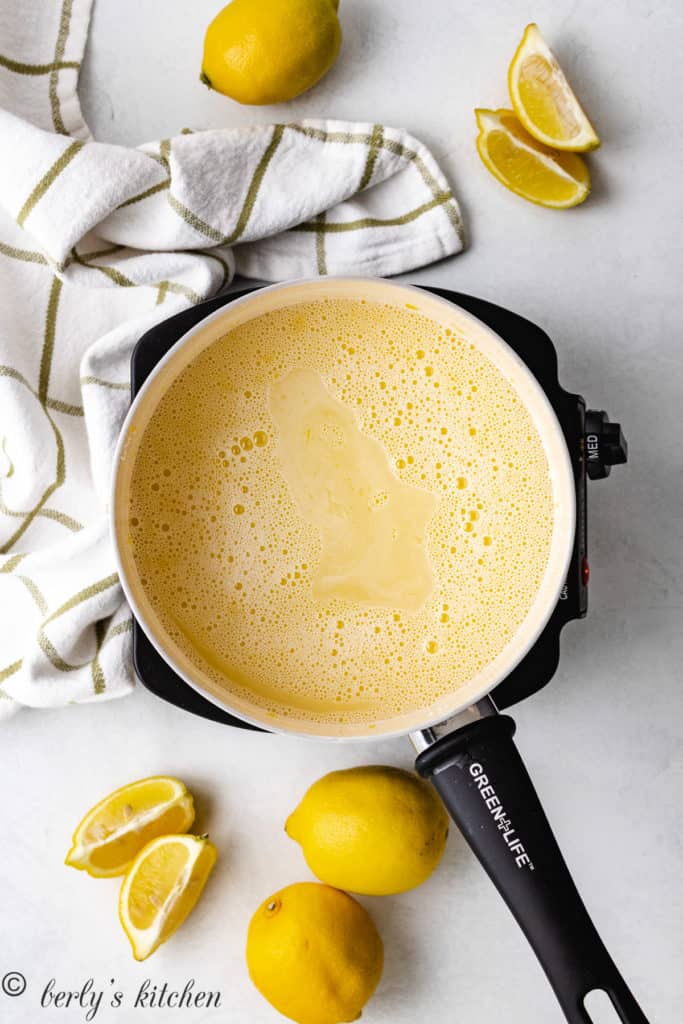 Top down view of egg yolks, cornstarch, and sugar mixed in a pan.