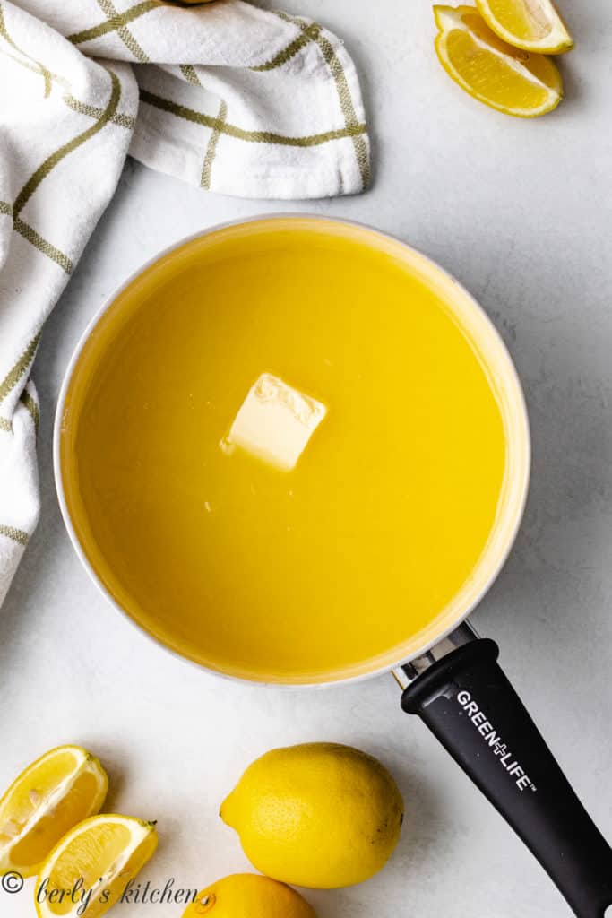 Top down view of butter and lemon filling in a saucepan.