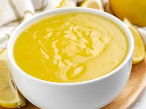 White bowl full of lemon curd.