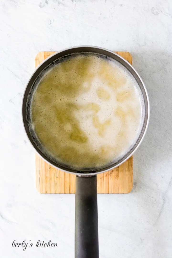 Top down view of butter and flour melted in a pan.