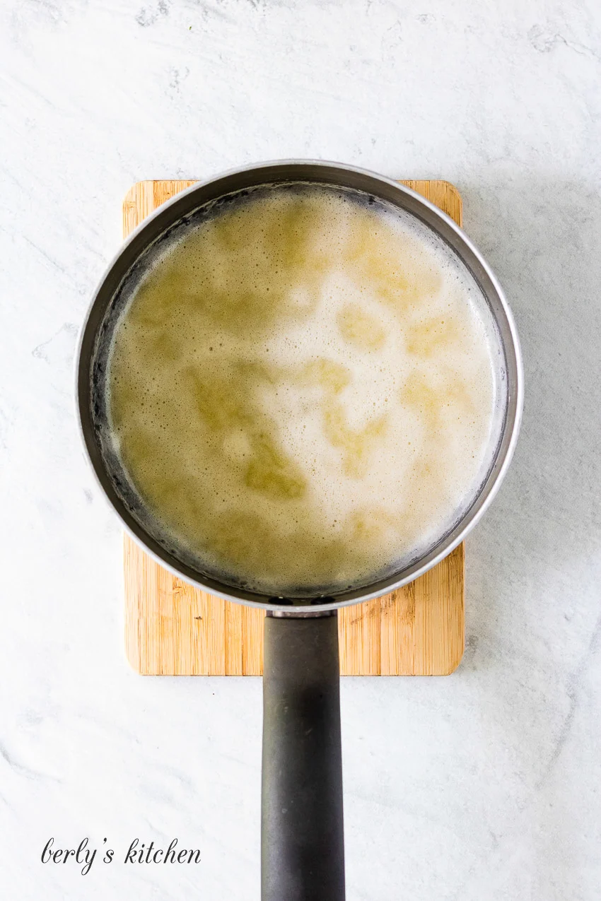 Top down view of butter and flour melted in a pan.