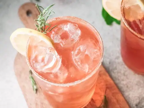 Top down view strawberry tequila cocktail with lemon slice.