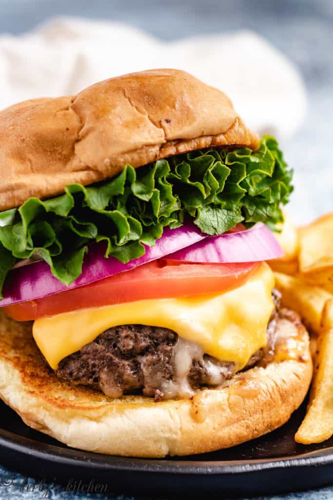 Close up photo of a hamburger with cheese.