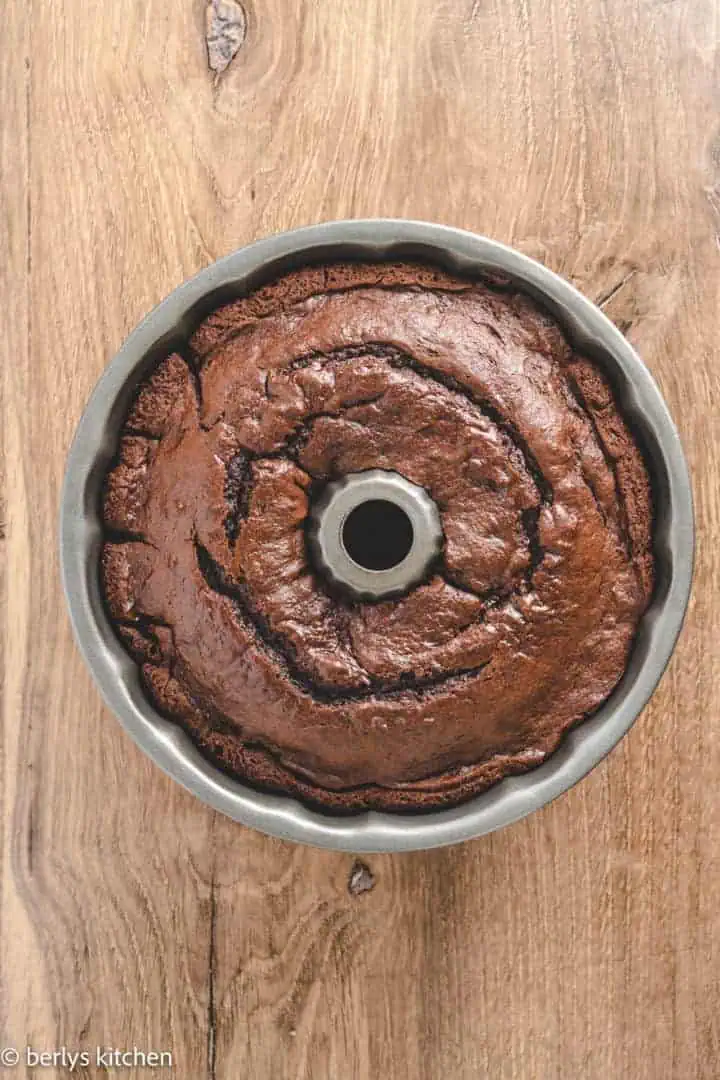 Top down view of chocolate bundt cake in a pan.