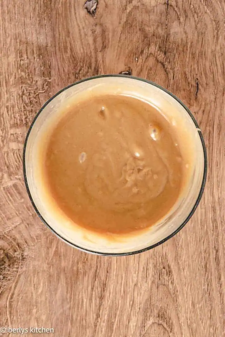 Top down view of peanut butter sauce in a bowl.