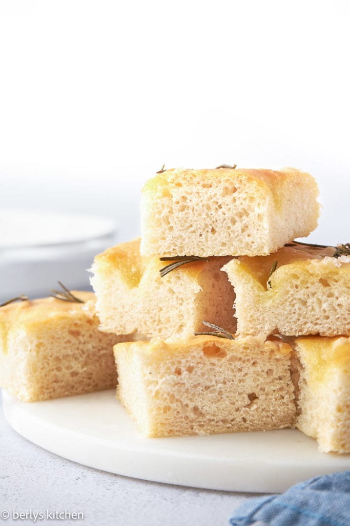 Close up of focaccia squares on a white plate.