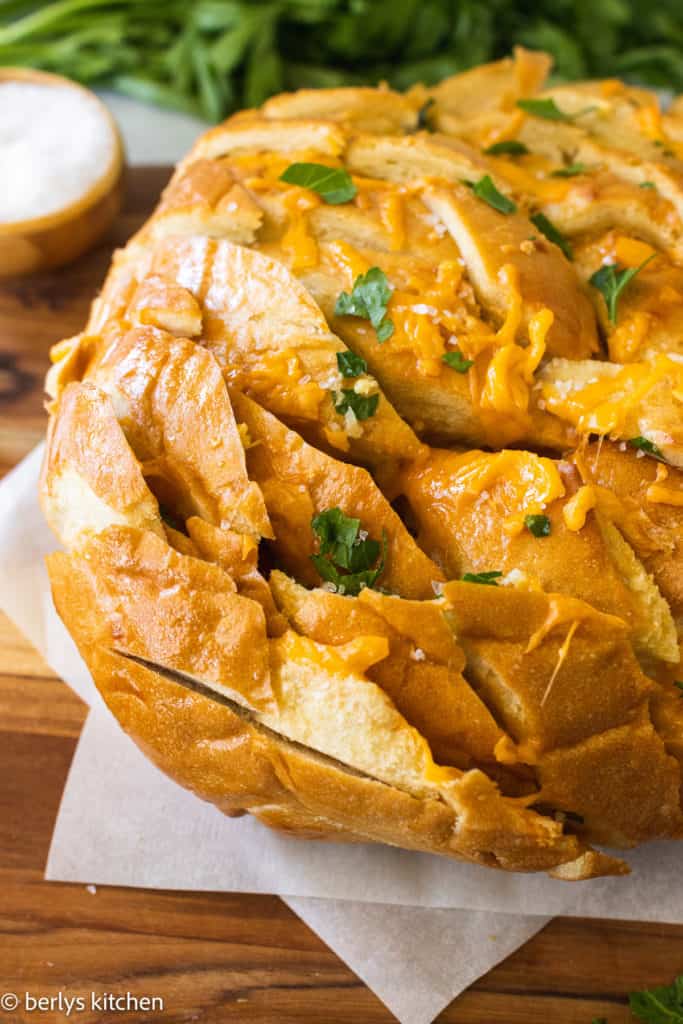 Close up view of a loaf of cheesy bread.