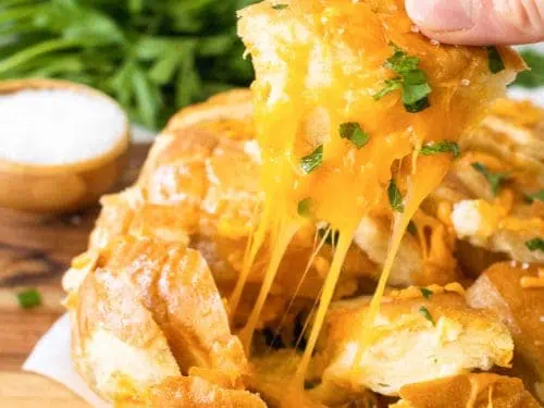Cheesy bread being pulled from the loaf.
