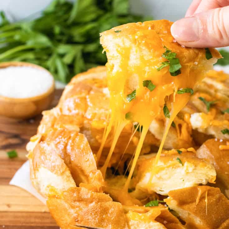 Cheesy bread being pulled from the loaf.