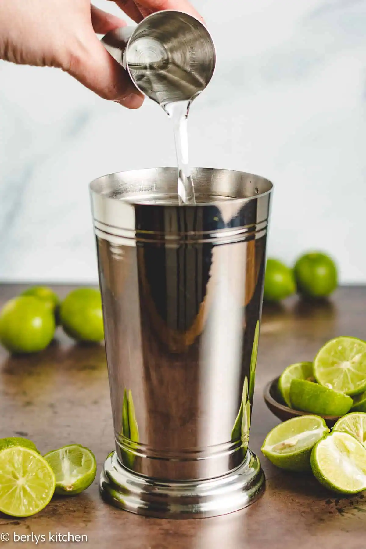 Coconut rum being poured into a drink shaker.