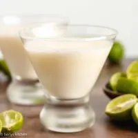Two glasses of key lime martini with heavy cream.