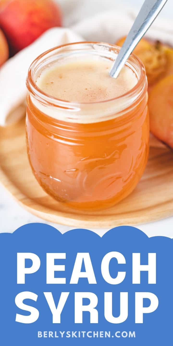 Jar of peach syrup on a small plate.